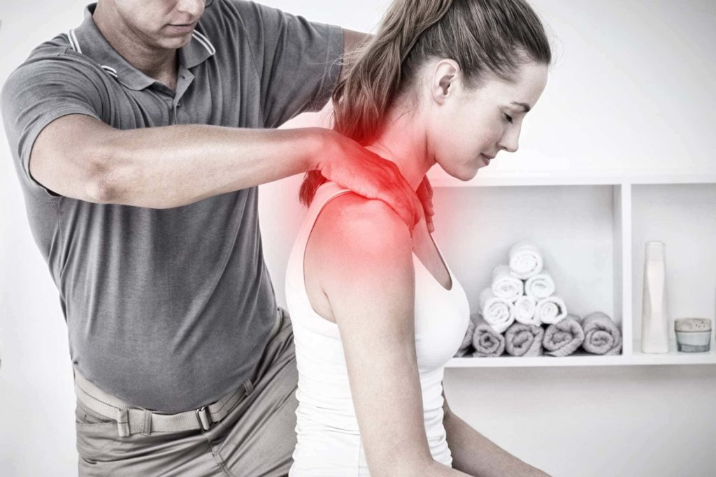 chiropractor working on woman's neck pain